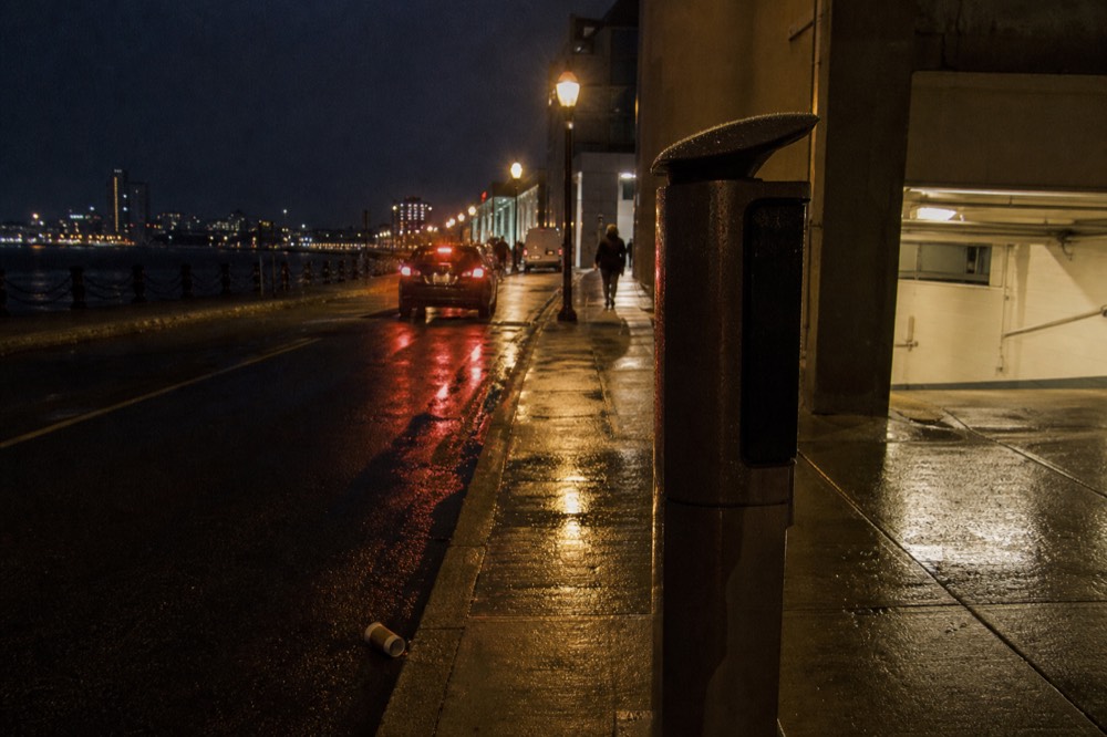 An evening street and garage entrance near the Boston waterfront