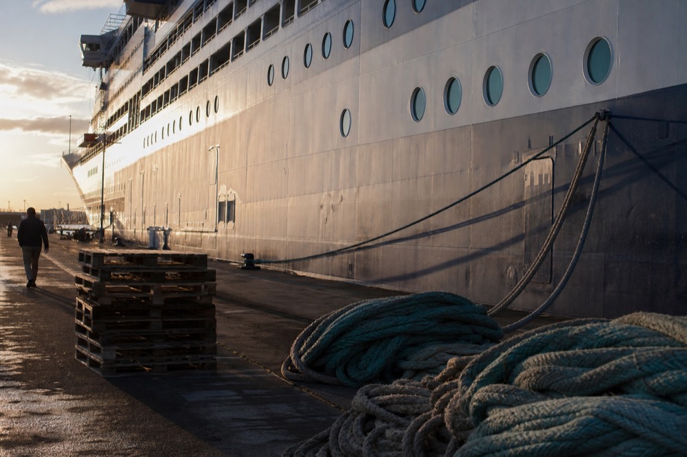 A cruise ship moored at a Boston pier in late afternoon light