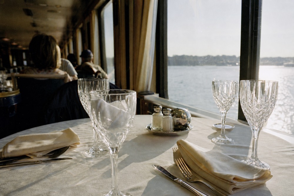 Elegant table setting with cloth napkins and glassware on a dinner cruise