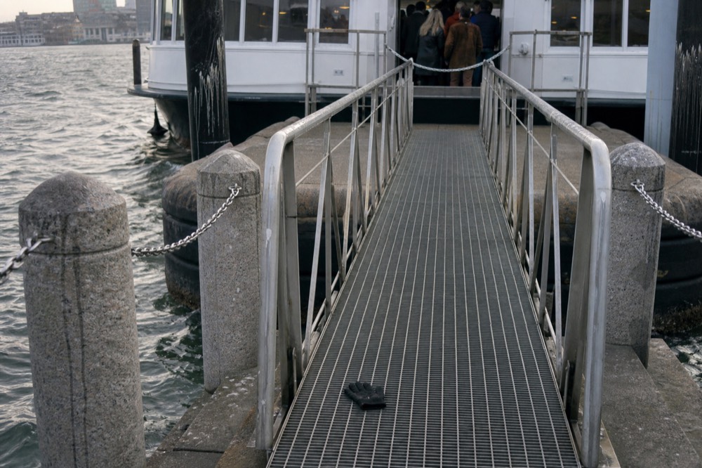 A gangway leading up to a docked dinner cruise vessel