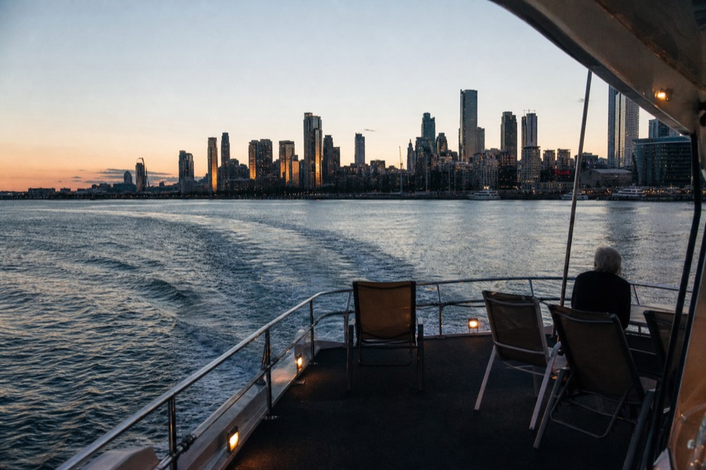 Dinner cruise vessel underway on Boston Harbor near the city skyline