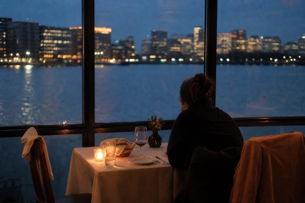 Couple at a private table on Odyssey dinner cruise with harbor view
