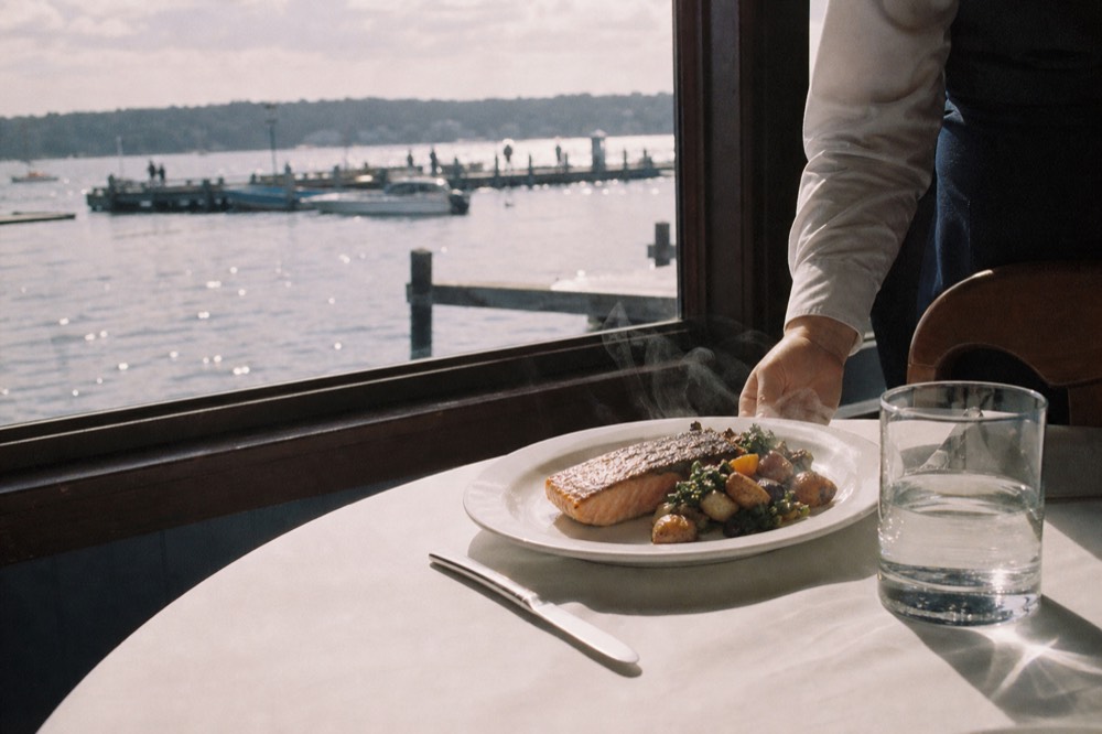 Plated dinner course on Odyssey cruise with harbor view